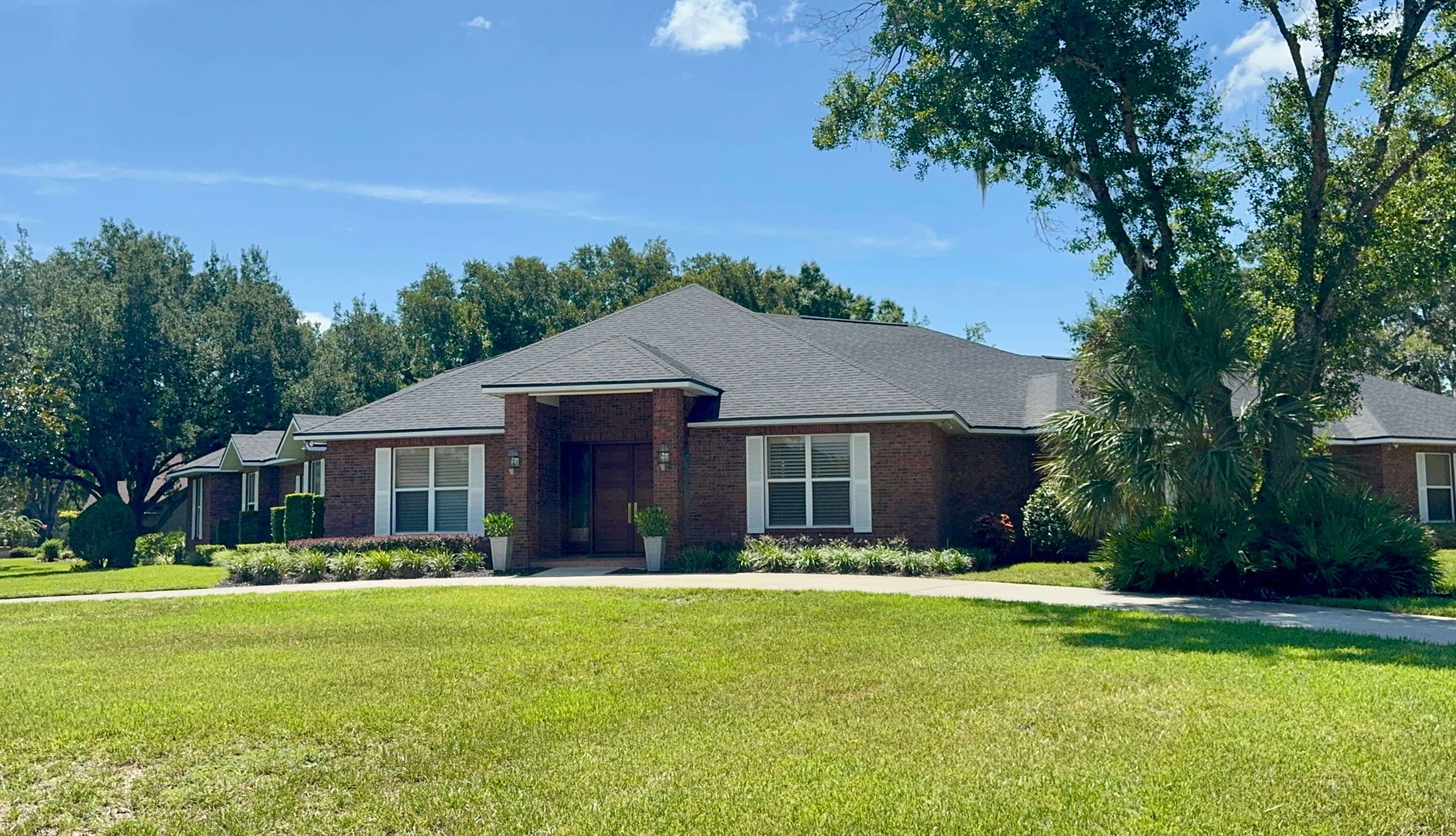 Brick home with palm tree landscaping on a Bloomingdale residential street in Valrico FL 33596